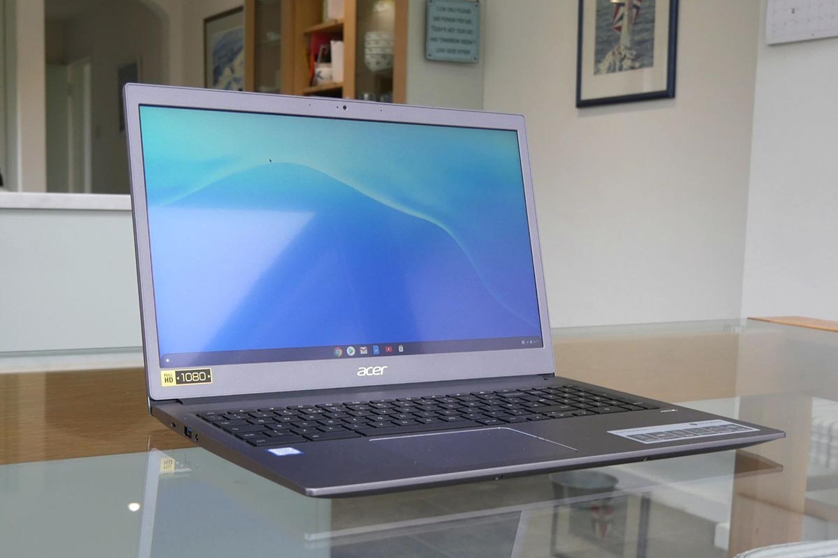 Silver Acer Chromebook open on a glass desk in a home office, illustrating everything you ever wanted to know about Chromebooks