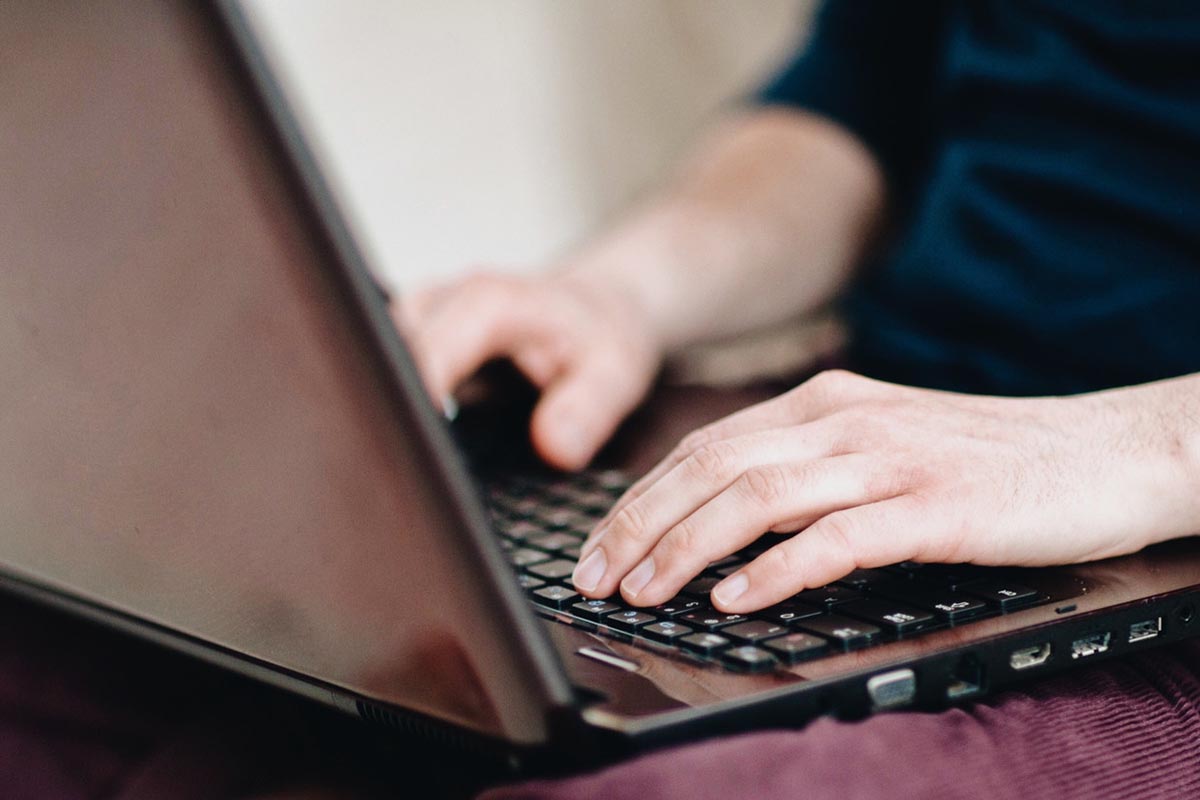 Close-up of a person typing on an Acer laptop, highlighting why recertified laptops are smart investments